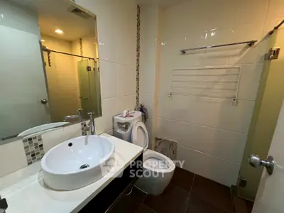 Modern bathroom with sleek fixtures and glass shower enclosure