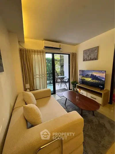 Cozy living room with modern decor and balcony view, perfect for relaxation and entertainment.