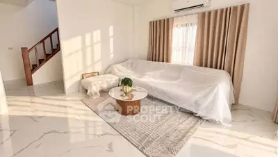 Spacious living room with elegant marble flooring and large windows