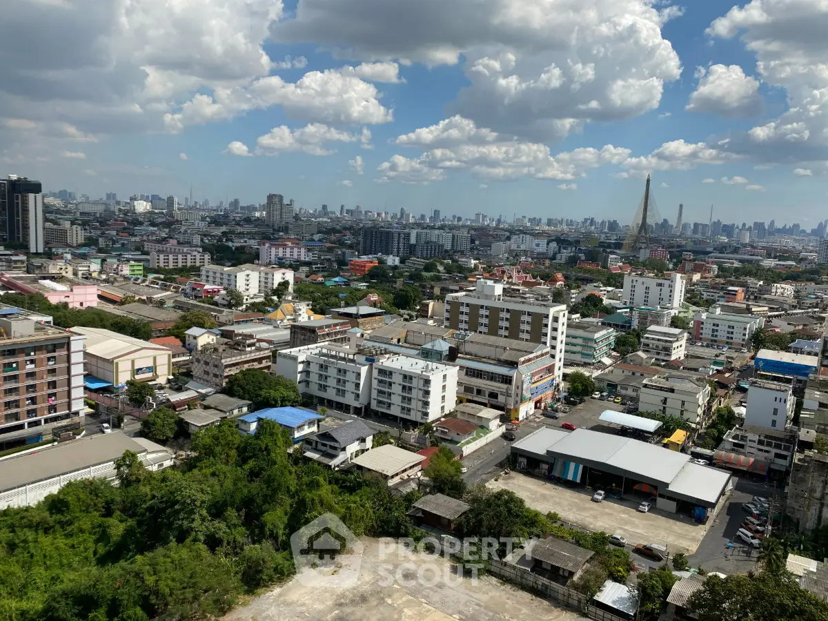 Stunning cityscape view showcasing urban skyline and lush greenery under a vibrant blue sky.