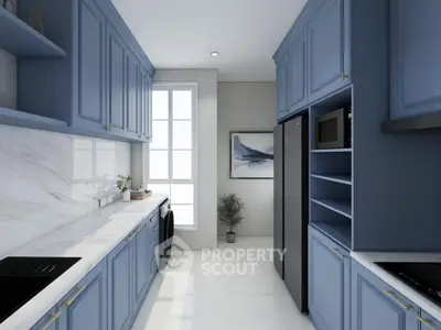 Modern kitchen with blue cabinetry, sleek appliances, and marble countertops.