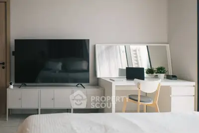 Modern bedroom with sleek TV setup and stylish desk area, perfect for work and relaxation.