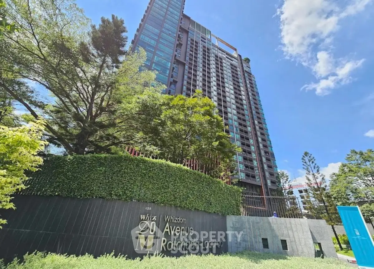Stunning high-rise building with lush greenery at Whizdom Avenue Ratchada-Ladprao.