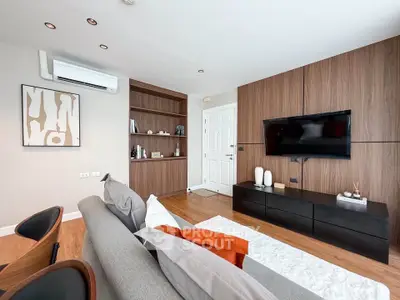 Modern living room with stylish wooden paneling and sleek furniture