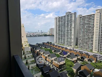 Stunning high-rise view of modern cityscape with river and residential buildings.
