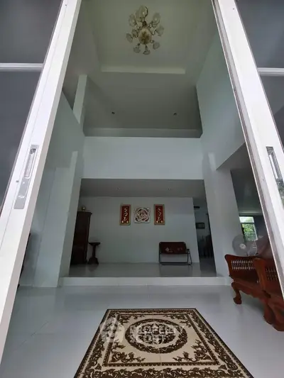 Spacious modern living room with high ceiling and elegant chandelier