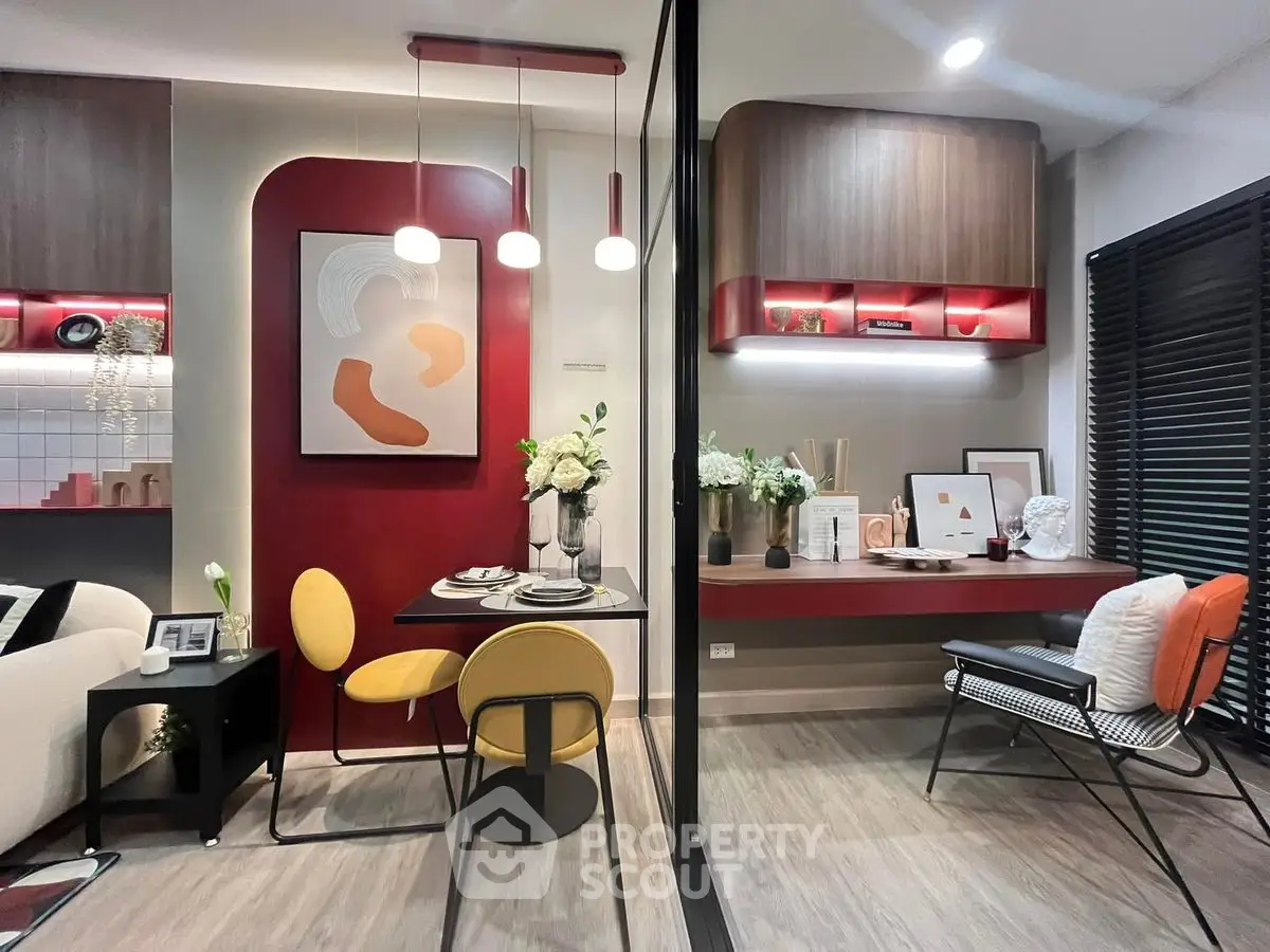 Modern living room with stylish decor and open layout, featuring contemporary furniture and vibrant accents.