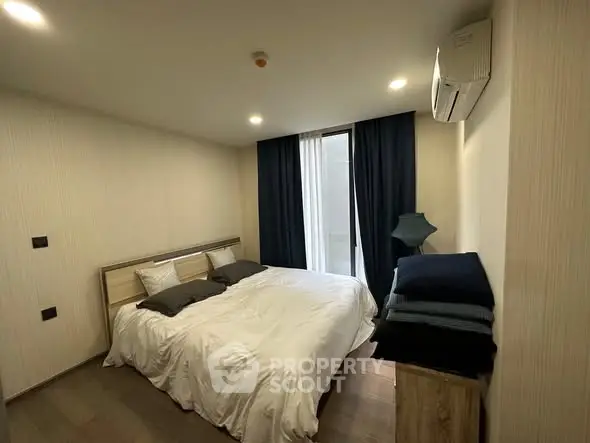 Modern bedroom with cozy double bed and stylish decor in a contemporary apartment.