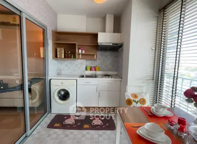 Charming modern kitchen with open layout and washing machine, perfect for urban living.