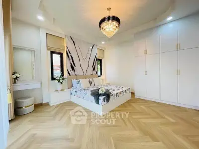 Luxurious bedroom with elegant chandelier and modern decor