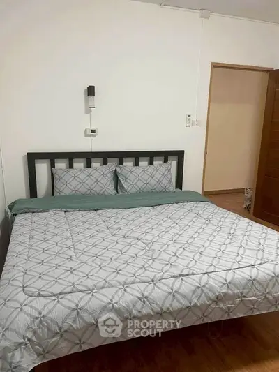 Cozy bedroom with modern decor and comfortable bedding in a stylish real estate property.