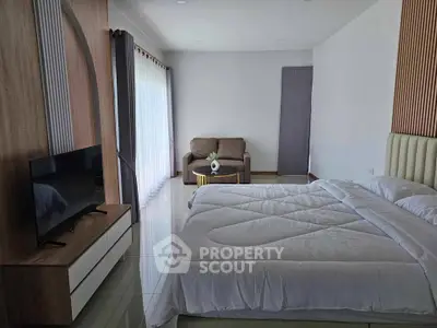 Spacious modern bedroom with sleek design and natural light