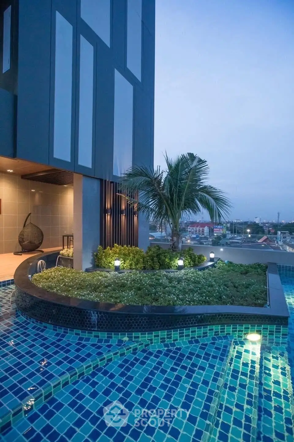 Stunning rooftop pool with lush greenery and city view