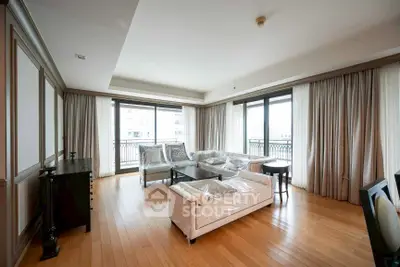 Spacious living room with elegant hardwood floors and large windows for natural light.