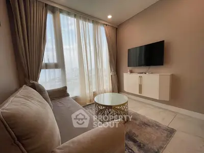 Modern living room with elegant sofa and wall-mounted TV, featuring large windows and stylish decor.