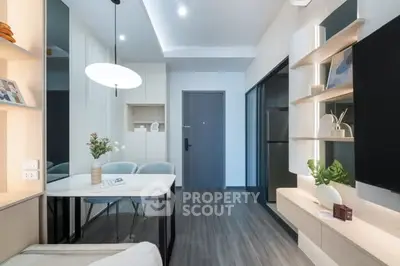Modern living room with sleek design and stylish decor, featuring a cozy seating area and contemporary lighting.