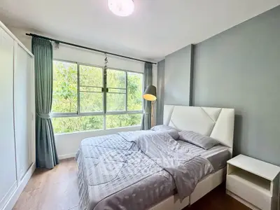 Bright and cozy bedroom with large window and modern decor