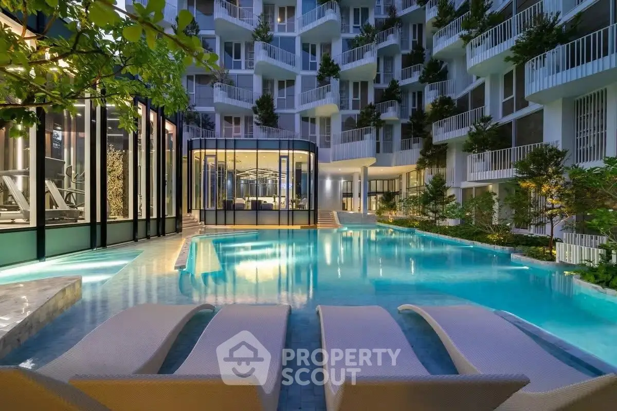 Luxurious modern apartment complex with stunning pool and lush greenery