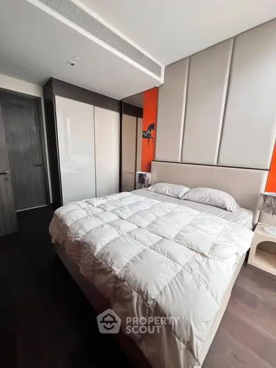 Modern bedroom with sleek design, featuring a cozy bed and stylish wardrobe, perfect for urban living.