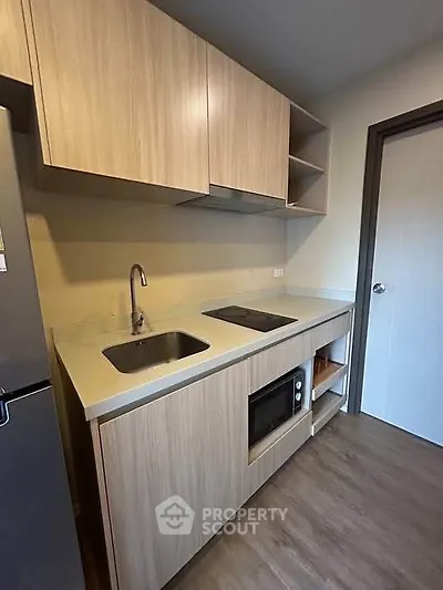 Modern kitchen with sleek cabinetry and built-in appliances in a compact layout.