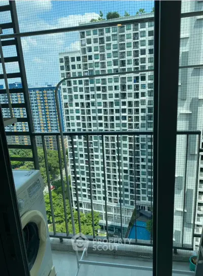 High-rise apartment balcony with city view and washing machine