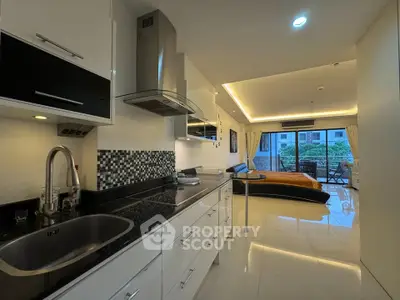 Modern open-plan kitchen and living area with sleek design and garden view.