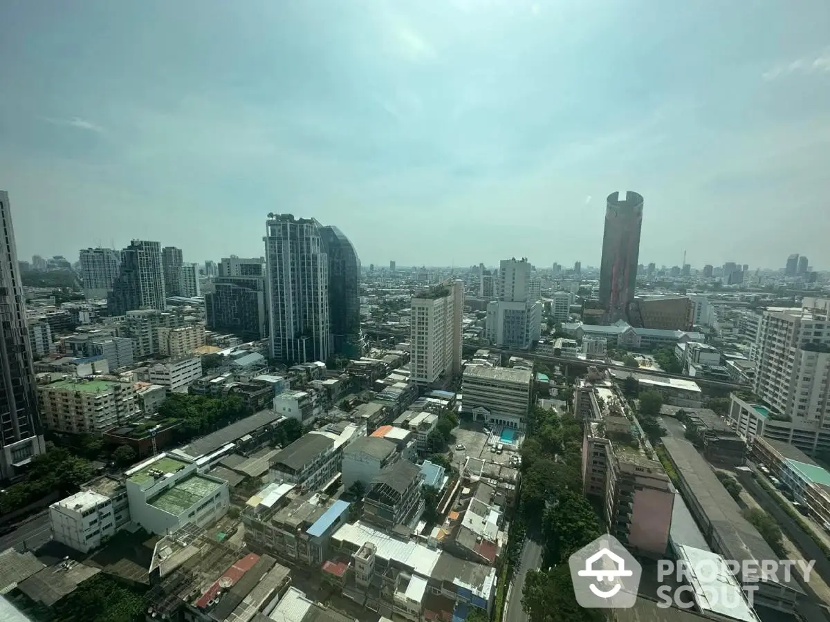 Stunning cityscape view from high-rise apartment showcasing urban skyline and architectural diversity.