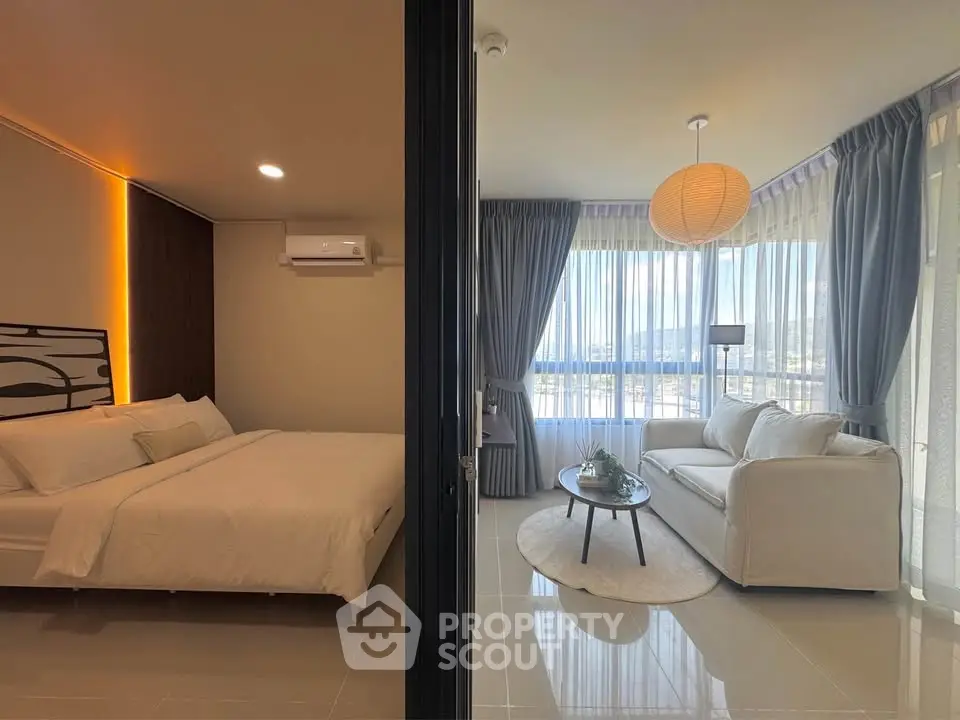 Modern apartment with spacious bedroom and bright living room featuring large windows and stylish decor.
