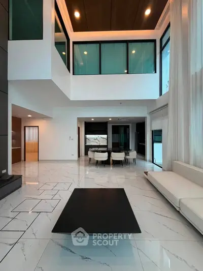 Luxurious modern living room with high ceilings and elegant marble flooring