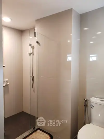 Modern bathroom with glass shower and sleek fixtures