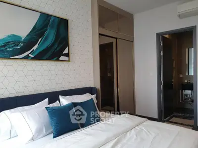 Modern bedroom with stylish decor and ensuite bathroom in luxury apartment