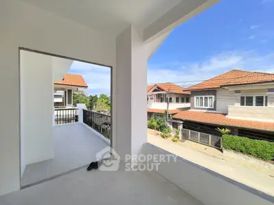 Spacious balcony with stunning neighborhood view in modern residential area.