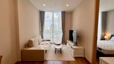 Modern living room with cozy sofa and large window offering city view