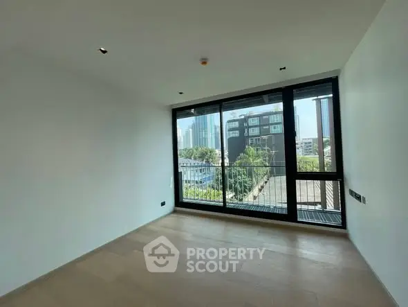 Spacious room with large windows offering a stunning city view, perfect for modern living.