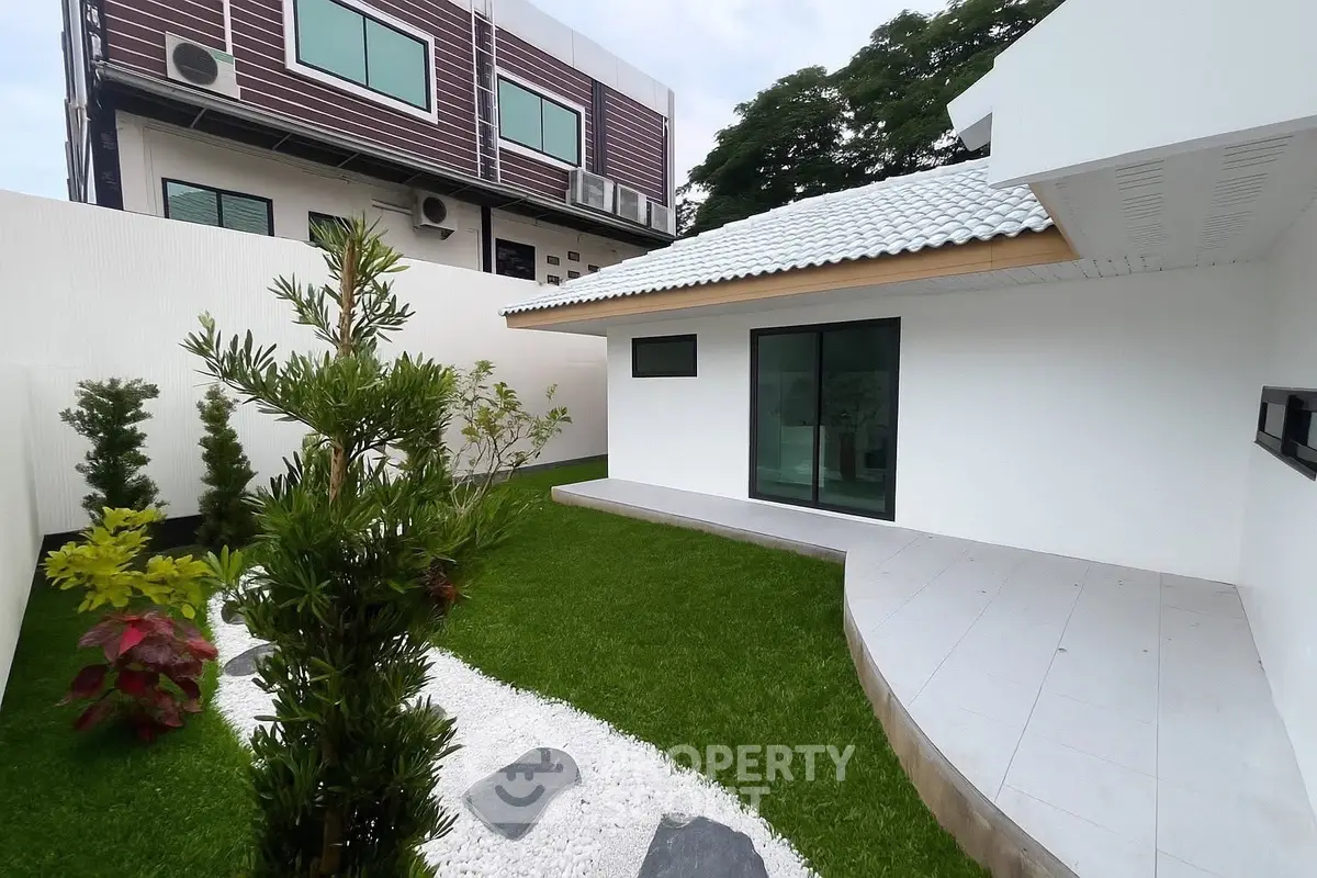 Modern minimalist house with lush garden and sleek exterior design