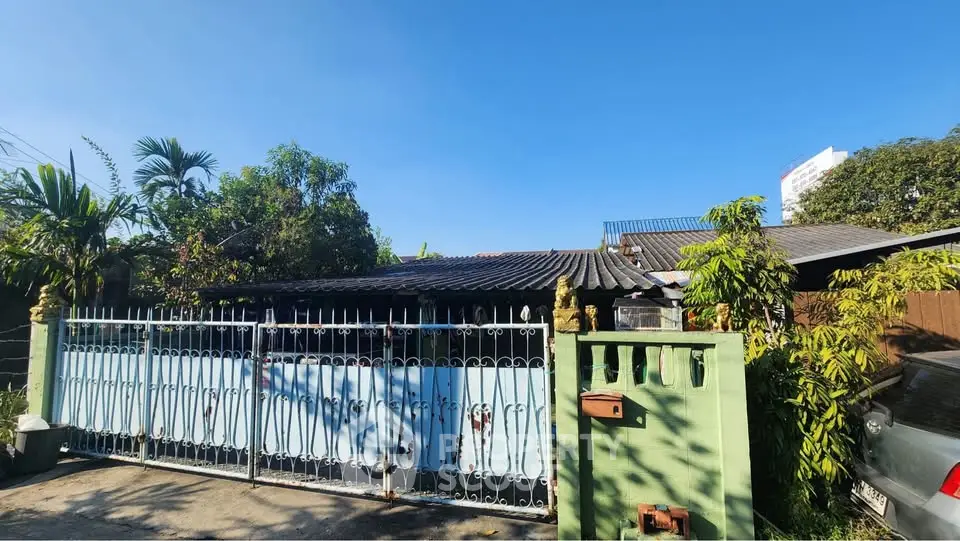 Charming single-story home with gated entrance and lush greenery, perfect for serene living.