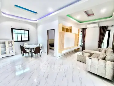 Modern living room with elegant dining area and stylish ceiling lights