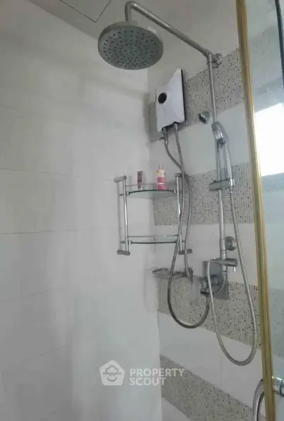 Modern bathroom with sleek shower fixtures and stylish tile design.