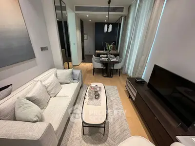 Modern living room with elegant dining area, featuring stylish furniture and contemporary decor.