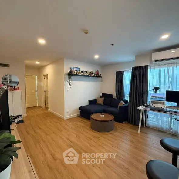 Spacious living room with modern decor and natural light