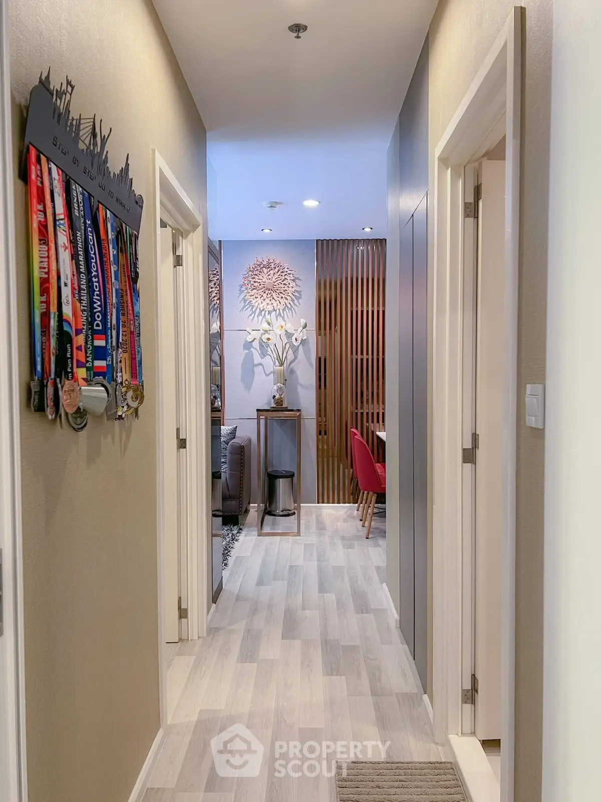 Modern hallway with stylish decor leading to a cozy living area and dining space.