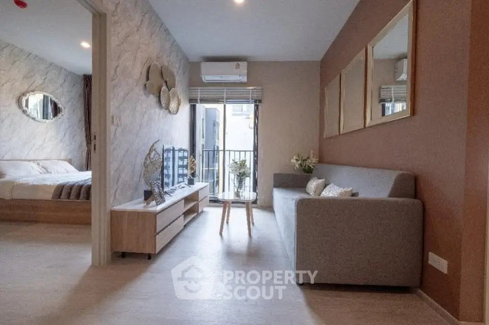 Modern living room with stylish decor and balcony view in a cozy apartment.