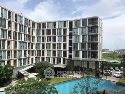 Modern apartment complex with pool and lush garden view