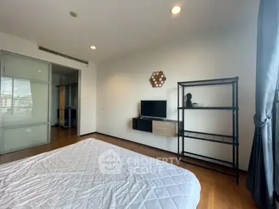 Spacious bedroom with modern decor and natural light