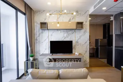 Modern living room with marble accent wall and sleek furniture