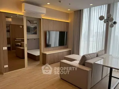 Modern living room with sleek wooden accents and large TV