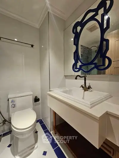 Elegant bathroom with unique mirror and modern fixtures