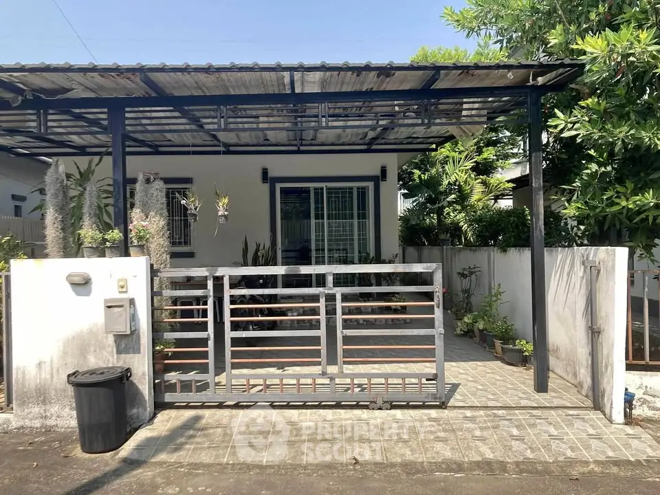 Charming single-story home with gated entrance and lush greenery