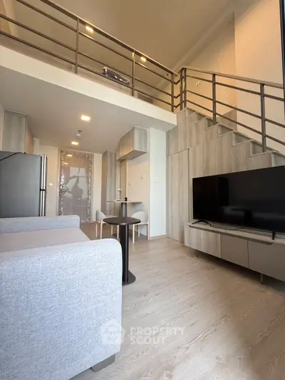 Modern loft apartment with open layout, stylish furniture, and high ceilings for spacious living.