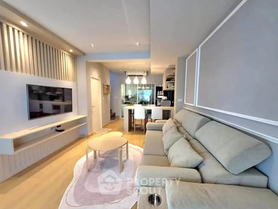 Modern living room with stylish decor and open kitchen layout